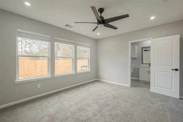 a bathroom with a shower sink vanity mirror and toilet