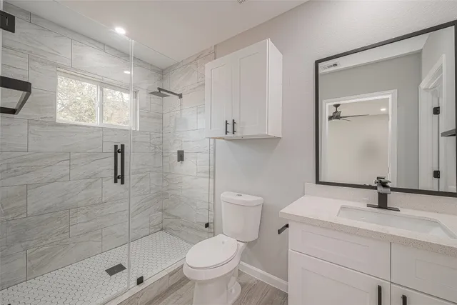 a view of an empty room and a ceiling fan