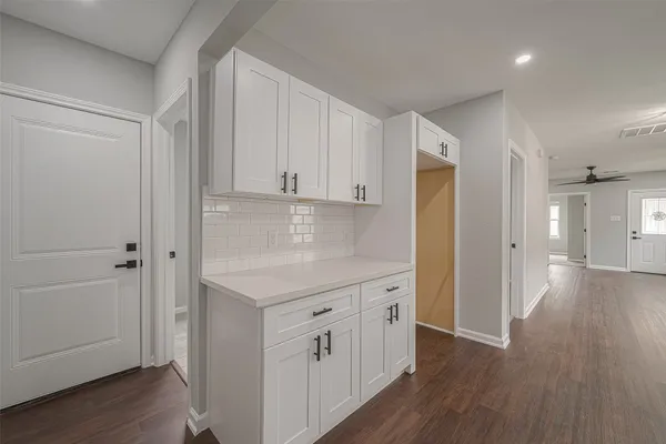 an empty room with wooden floor