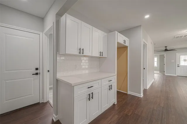 an empty room with wooden floor