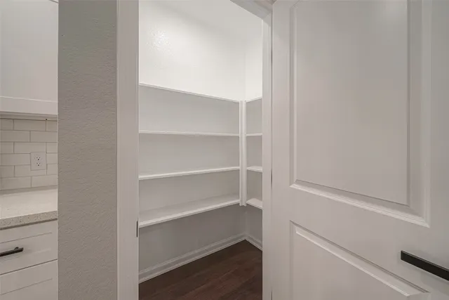 a view of walk in closet with empty racks