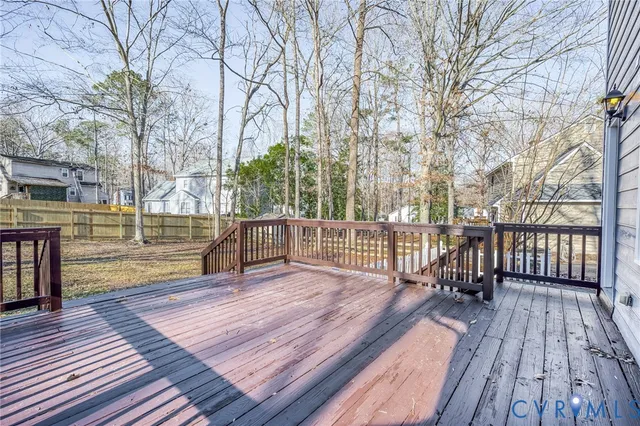 a view of a balcony with wooden floor and fence