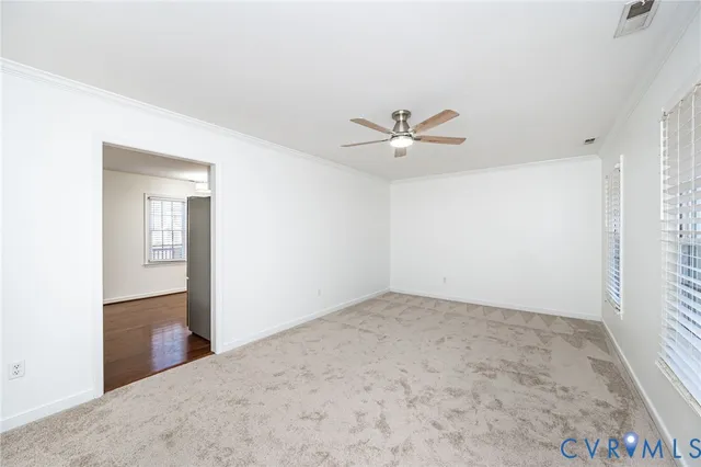 an empty room with closet and windows