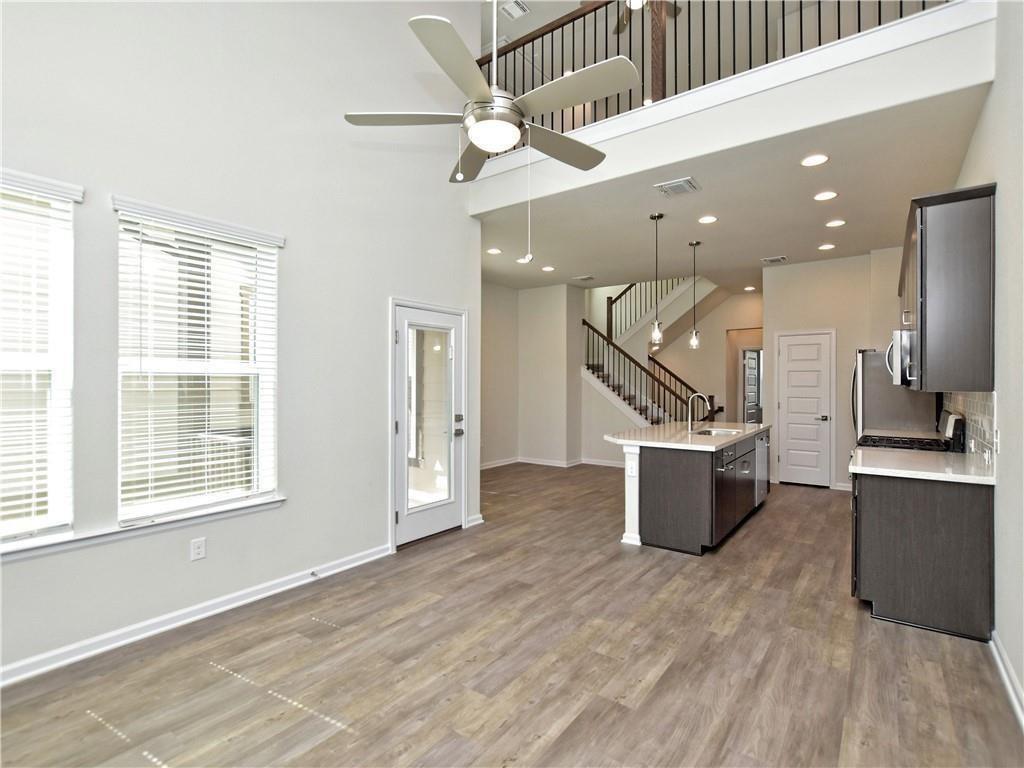 13611 Terrett Trace, Unit 108 Austin, TX 78717 - Photo 15 of 33 a view of a kitchen with a sink and a wooden floor