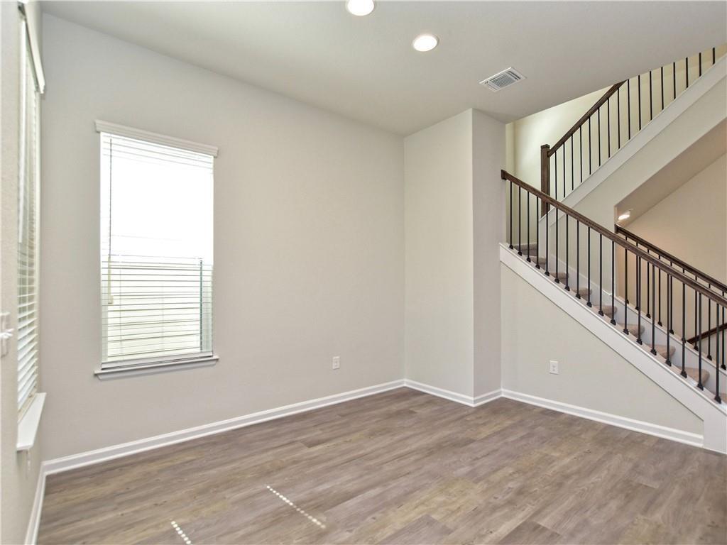 13611 Terrett Trace, Unit 108 Austin, TX 78717 - Photo 16 of 33 a view of an empty room with wooden floor and a window