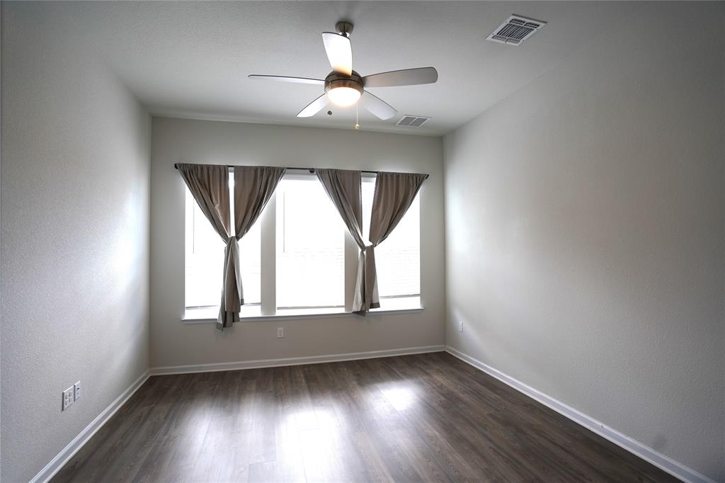 13611 Terrett Trace, Unit 108 Austin, TX 78717 - Photo 18 of 33 an empty room with wooden floor chandelier and windows