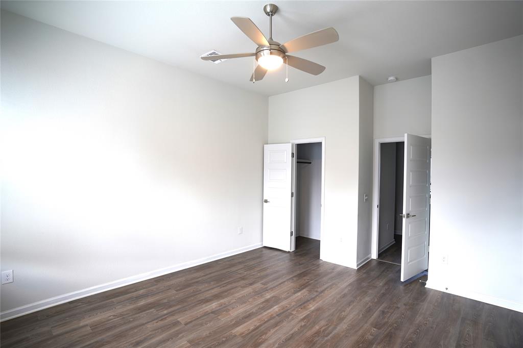 13611 Terrett Trace, Unit 108 Austin, TX 78717 - Photo 19 of 33 a view of an empty room with wooden floor