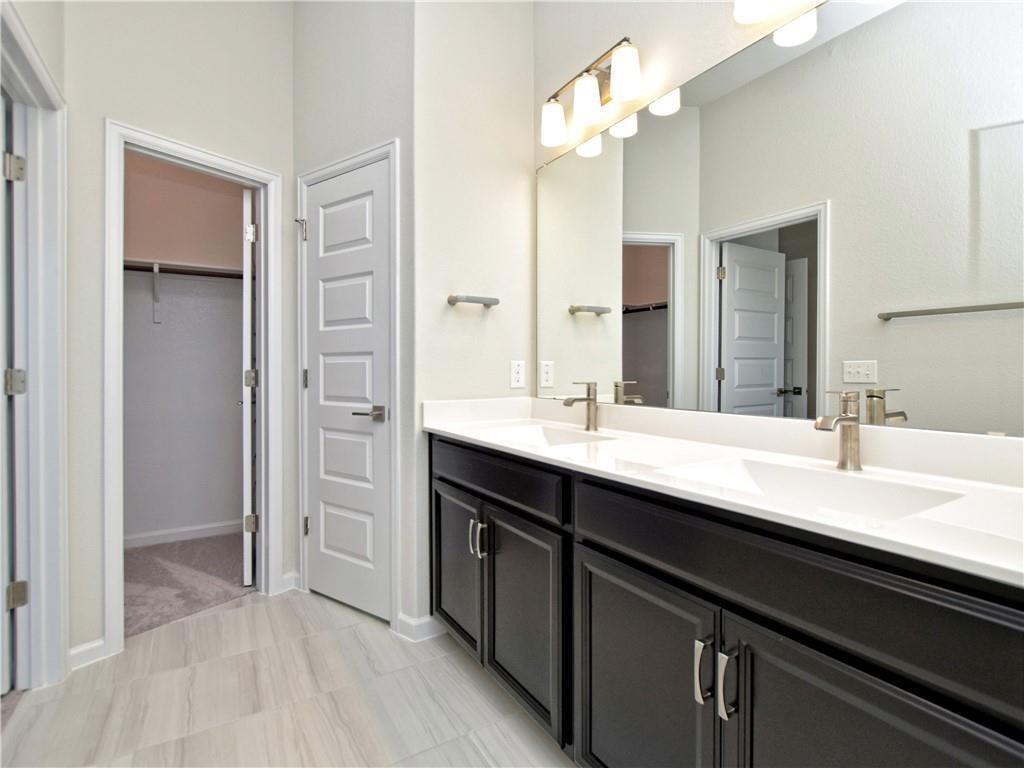 13611 Terrett Trace, Unit 108 Austin, TX 78717 - Photo 21 of 33 a bathroom with a sink double vanity and a mirror