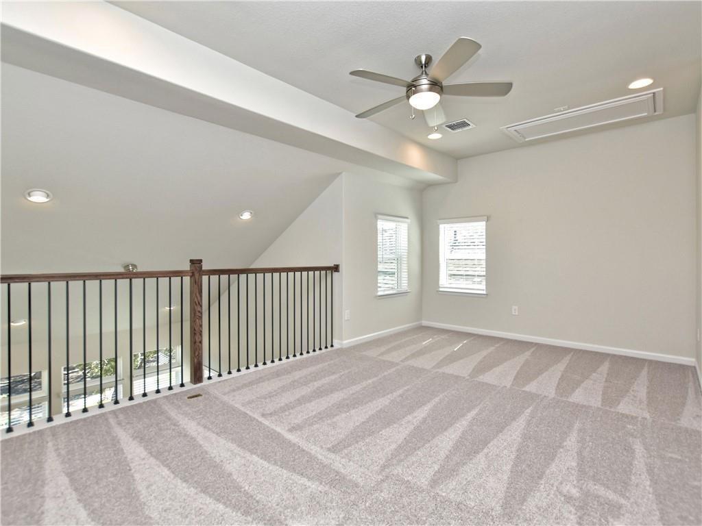 13611 Terrett Trace, Unit 108 Austin, TX 78717 - Photo 23 of 33 a view of a livingroom with a ceiling fan and window