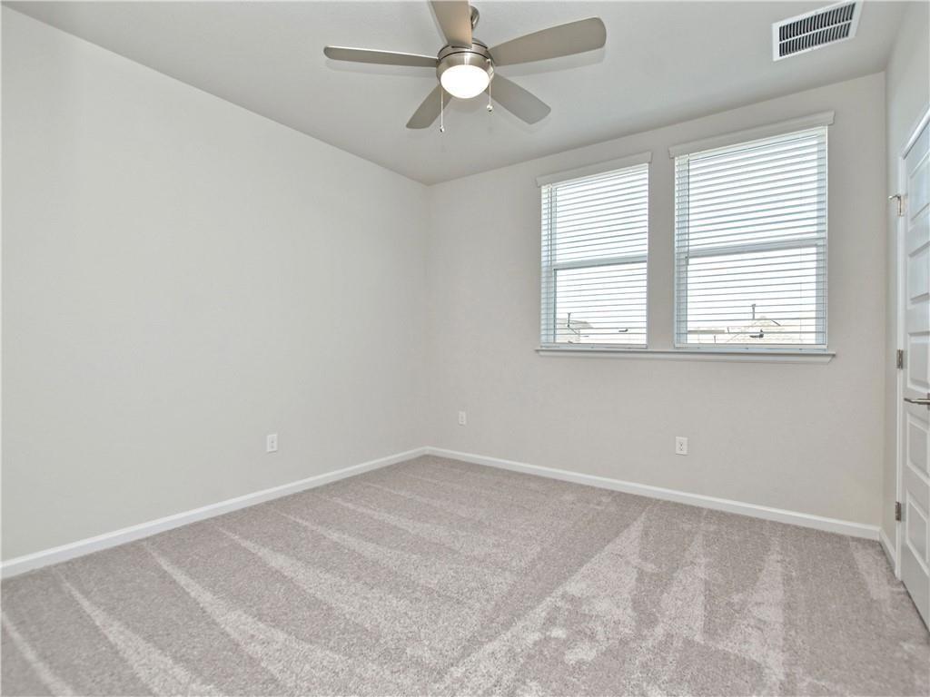 13611 Terrett Trace, Unit 108 Austin, TX 78717 - Photo 25 of 33 an empty room with a window and a fan