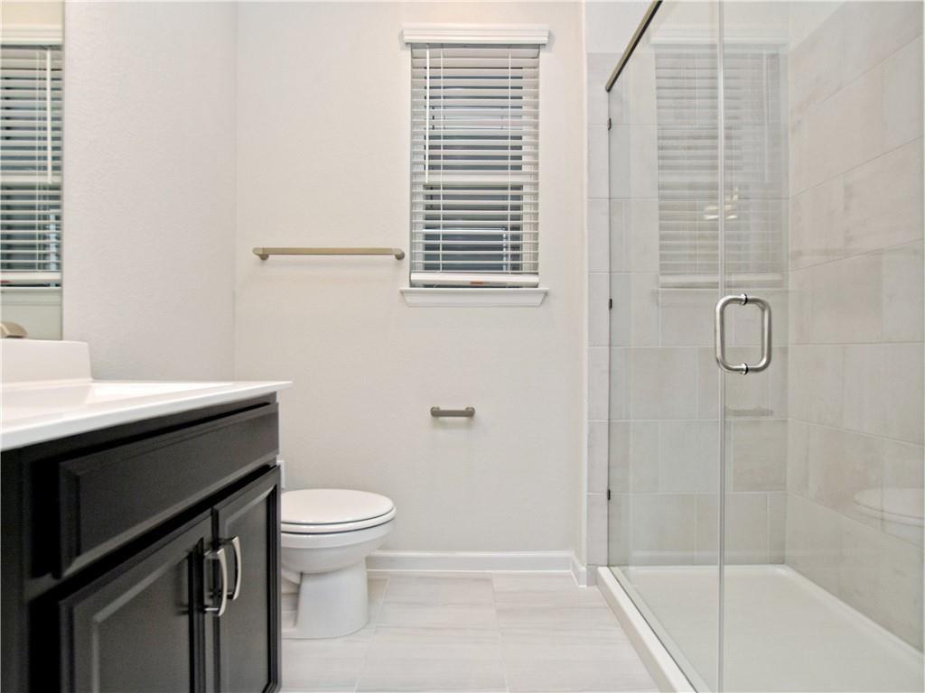13611 Terrett Trace, Unit 108 Austin, TX 78717 - Photo 26 of 33 a bathroom with a sink a toilet and shower