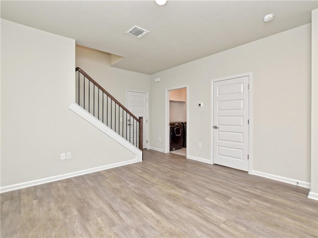 13611 Terrett Trace, Unit 108 Austin, TX 78717 - Photo 5 of 33 a view of an empty room with wooden floor