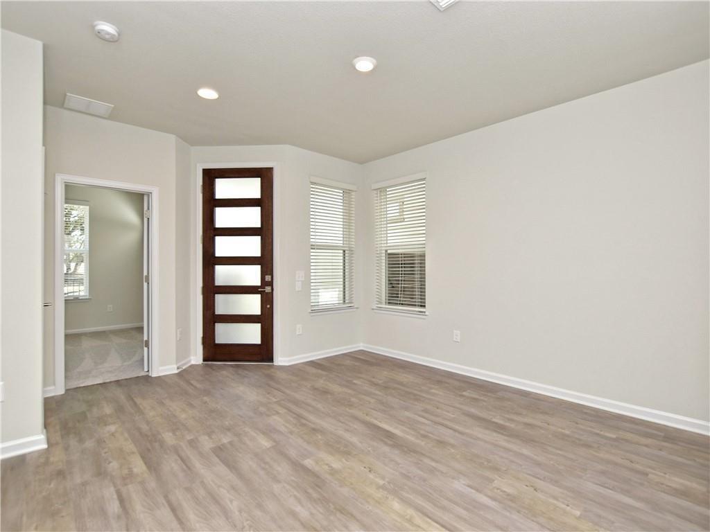 13611 Terrett Trace, Unit 108 Austin, TX 78717 - Photo 6 of 33 wooden floor in an empty room with a window