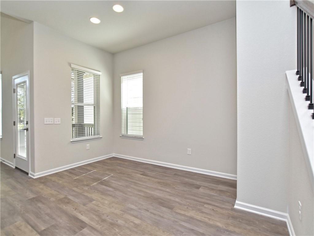 13611 Terrett Trace, Unit 108 Austin, TX 78717 - Photo 7 of 33 wooden floor in an empty room with a window