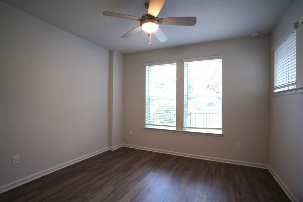 13611 Terrett Trace, Unit 108 Austin, TX 78717 - Photo 8 of 33 an empty room with wooden floor ceiling fan and windows