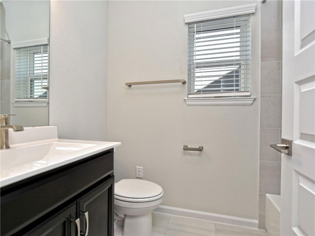 13611 Terrett Trace, Unit 108 Austin, TX 78717 - Photo 9 of 33 a bathroom with a sink a toilet and a window