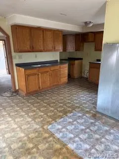 a kitchen with stainless steel appliances a cabinets and window