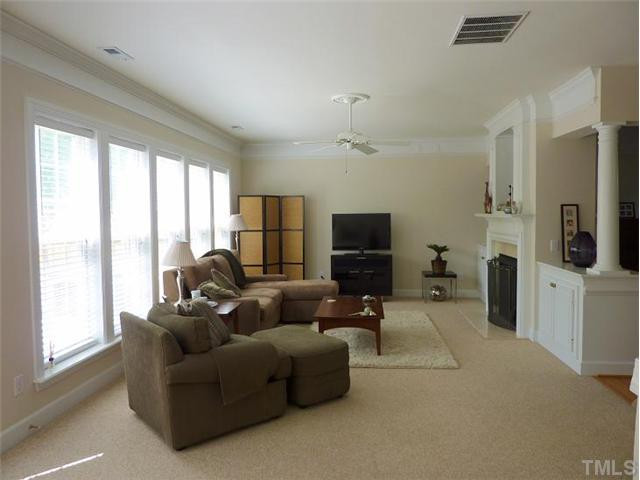 3713 Old Post Road Raleigh, NC 27612 - Photo 5 of 12 Spacious family room with gas log fireplace, built-in cabinets and new blinds.