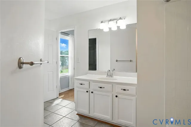 a bathroom with a double vanity sink a mirror and a shower