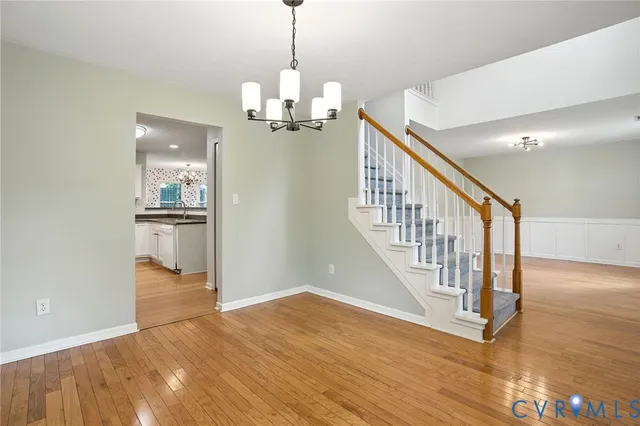 a view of a hallway with wooden floor and entryway