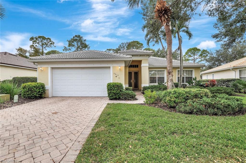 3617 Recreation Lane Naples, FL 34116 - Photo 1 of 25 a front view of a house with a yard and potted plants