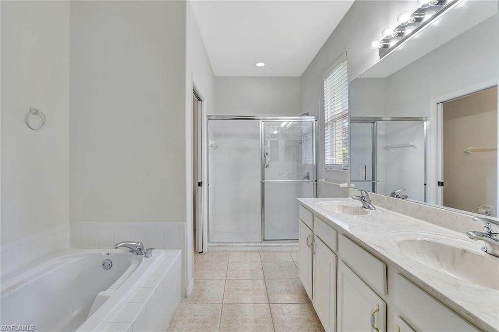 3617 Recreation Lane Naples, FL 34116 - Photo 16 of 25 a bathroom with a double vanity sink mirror and shower