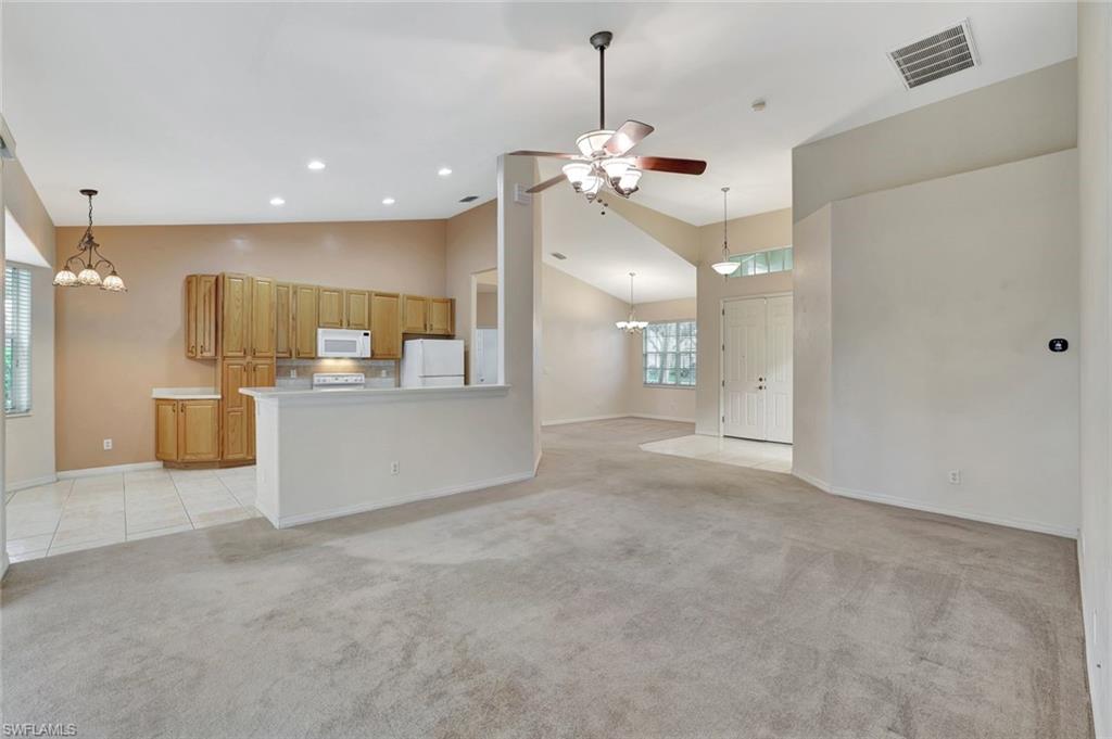 3617 Recreation Lane Naples, FL 34116 - Photo 8 of 25 a view of a big room with a chandelier fan and windows