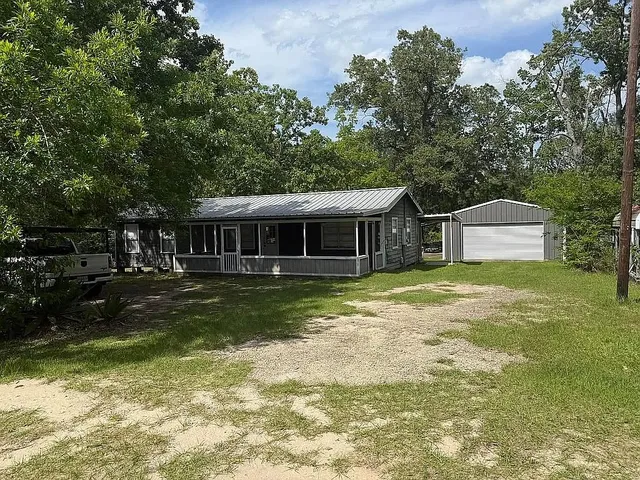 a front view of a house with a yard table and chairs