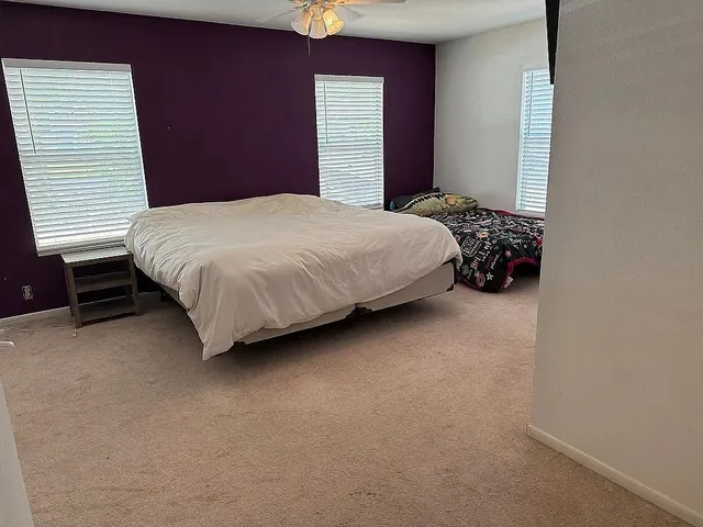 a bedroom with a bed and a window