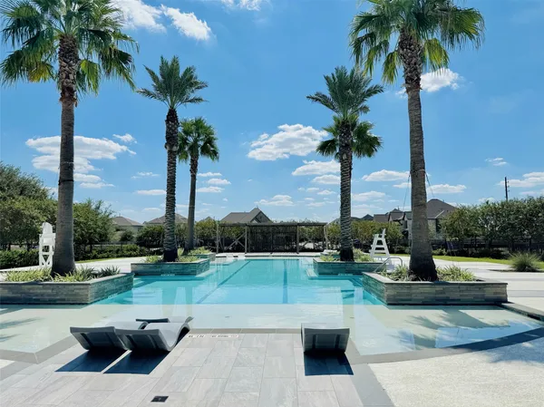 a swimming pool with outdoor seating and yard