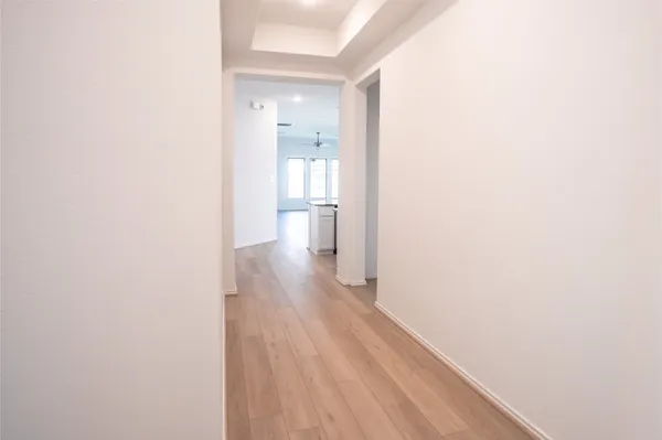 a view of a room with wooden floor