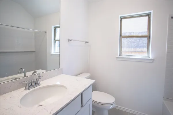 a bathroom with a sink toilet and a mirror