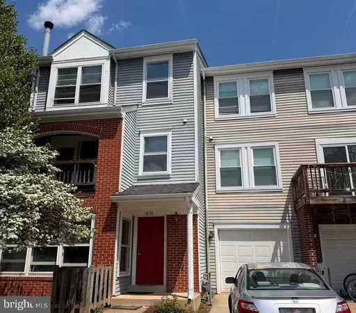 a view of a house with car parked