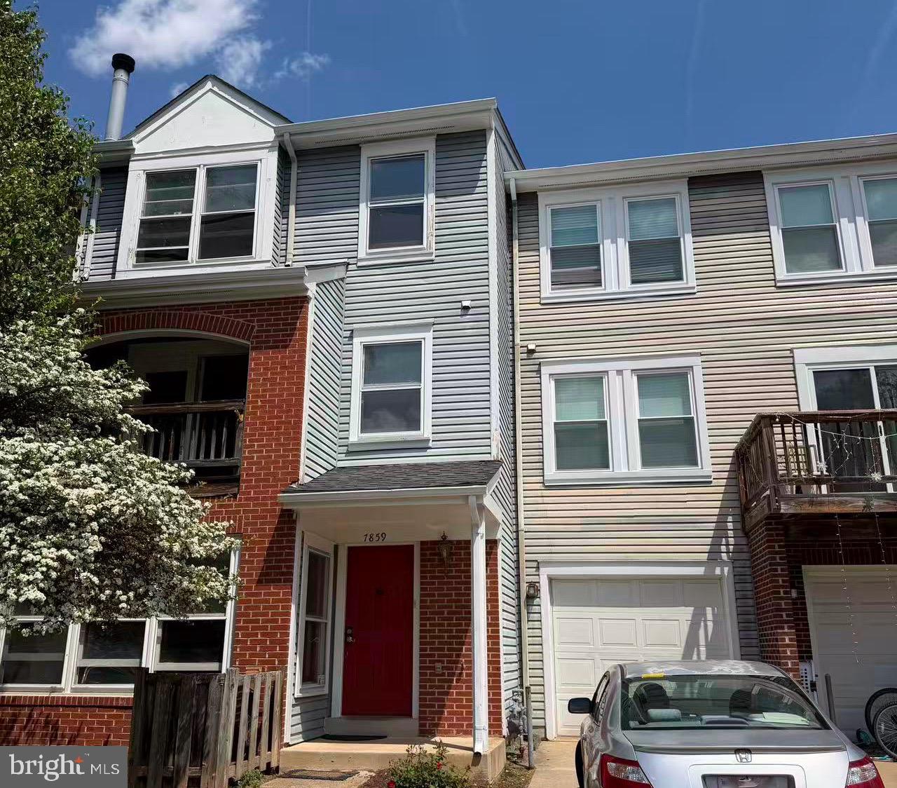 a view of a house with car parked