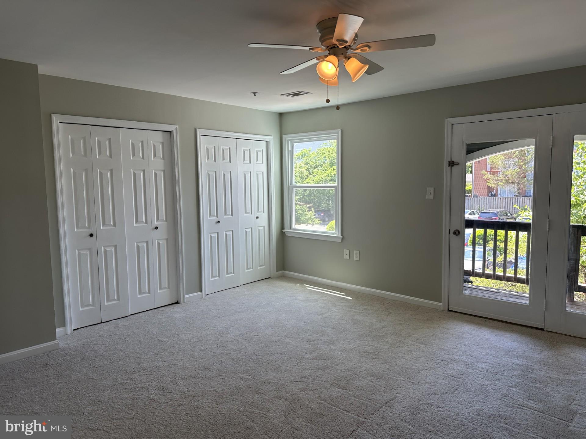 7859 Apache Ridge Court Manassas, VA 20109 - Photo 14 of 27 an empty room with windows and chandelier fan