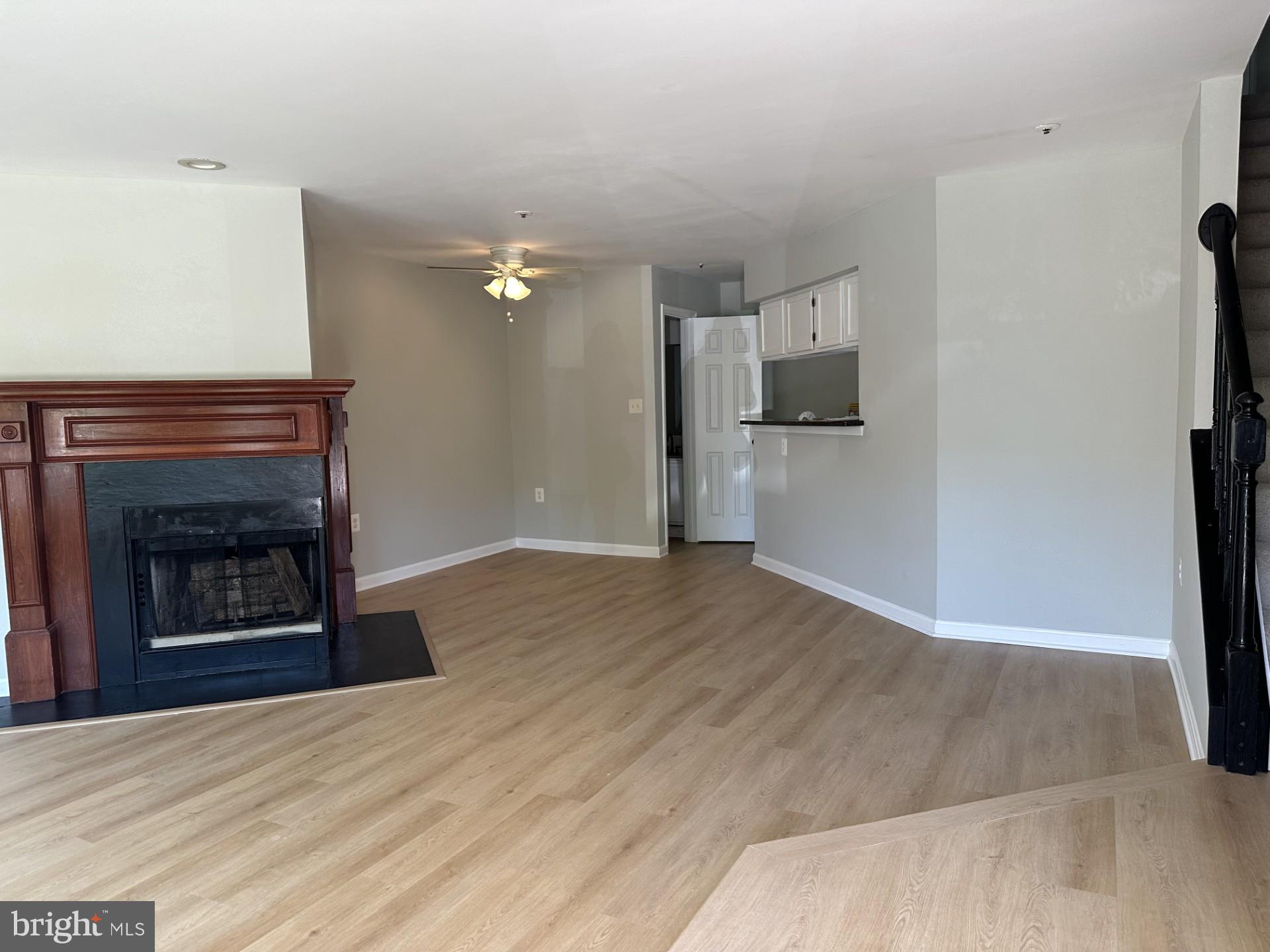 7859 Apache Ridge Court Manassas, VA 20109 - Photo 2 of 27 a view of an empty room with a fireplace and wooden floor