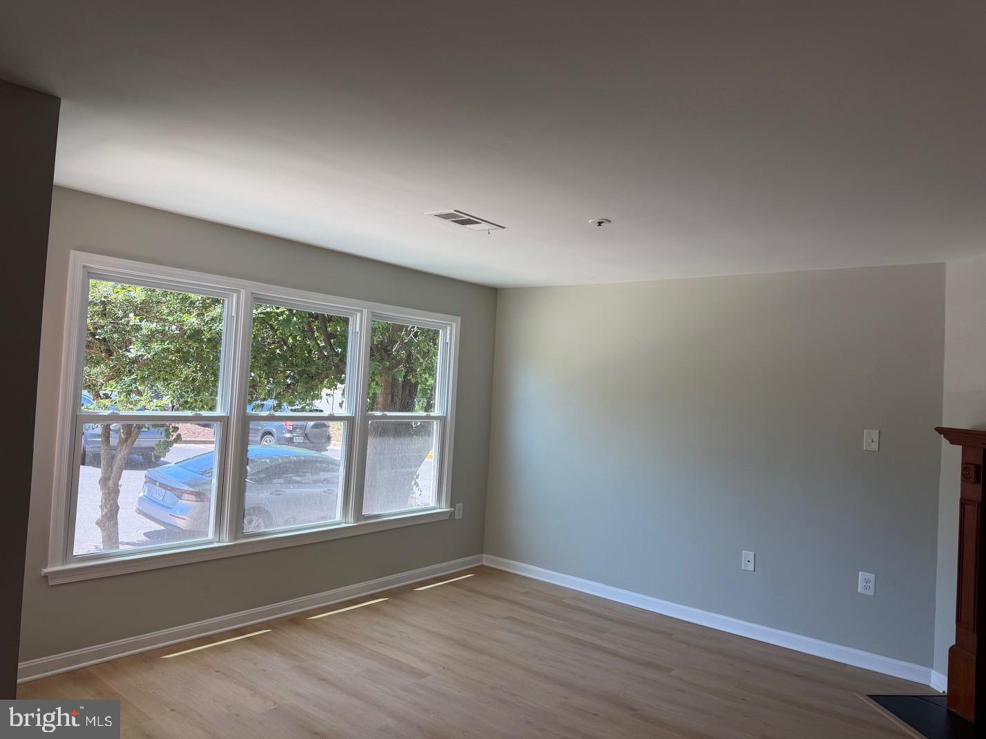 7859 Apache Ridge Court Manassas, VA 20109 - Photo 5 of 27 a view of an empty room with wooden floor and a window