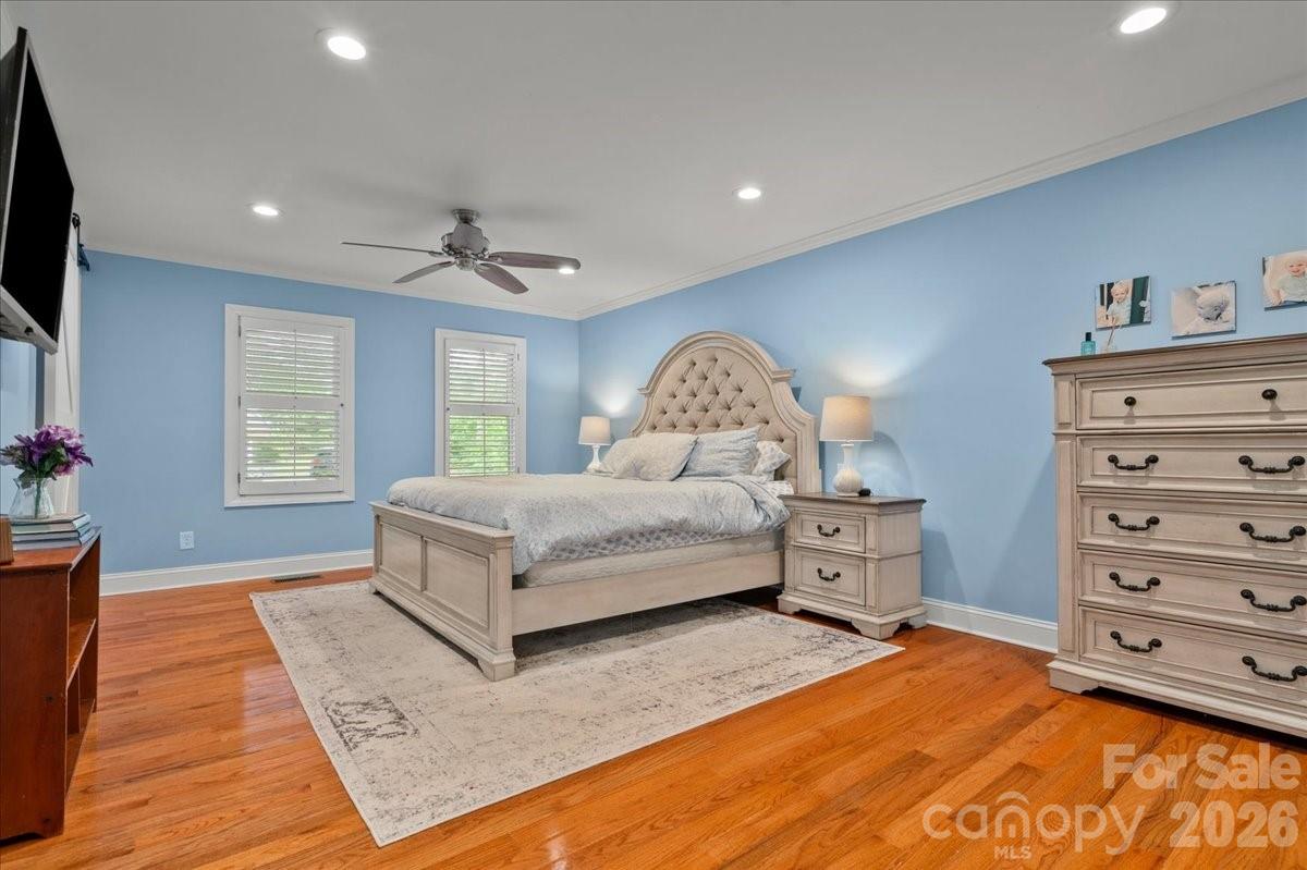 209 Fairway Road Cheraw, SC 29520 - Photo 15 of 48 a spacious bedroom with a large bed and a chandelier