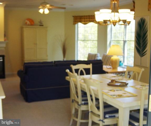 702 Runabout Loop, Unit V10 Solomons, MD 20688 - Photo 15 of 30 a view of a dining room with furniture and a chandelier