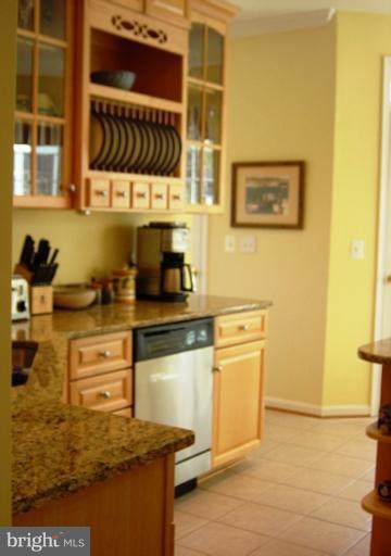 702 Runabout Loop, Unit V10 Solomons, MD 20688 - Photo 22 of 30 a kitchen with stainless steel appliances granite countertop a stove a sink and a refrigerator