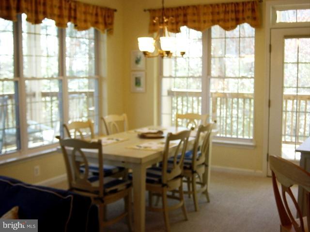 702 Runabout Loop, Unit V10 Solomons, MD 20688 - Photo 25 of 30 a view of a dining room with furniture and a window