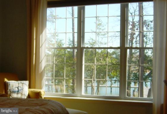 702 Runabout Loop, Unit V10 Solomons, MD 20688 - Photo 27 of 30 a bedroom with a large bed and a large window