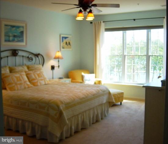 702 Runabout Loop, Unit V10 Solomons, MD 20688 - Photo 7 of 30 a bedroom with a bed and window