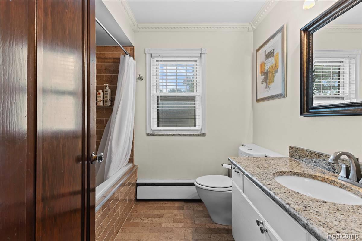 43 Wellesley Drive Pleasant Ridge, MI 48069 - Photo 16 of 52 Bathroom with a window, white vanity, granite countertop, and integrated sink