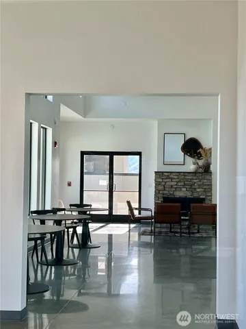 a living room with furniture and a floor to ceiling window