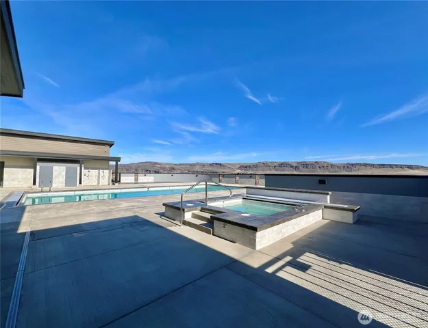 a view of a swimming pool and lounge chair