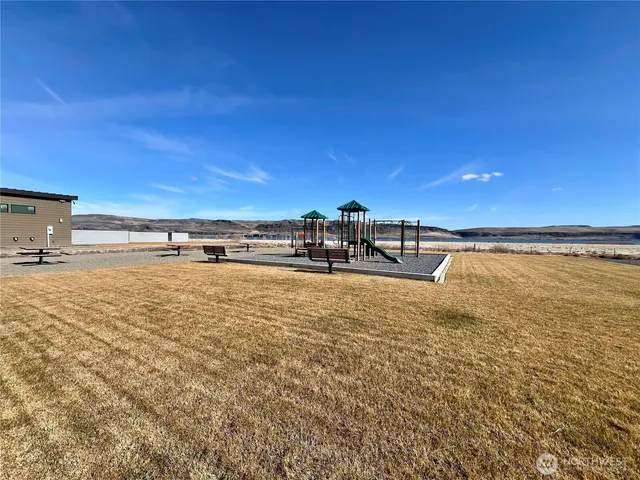 a view of a lake with a car park in front of it