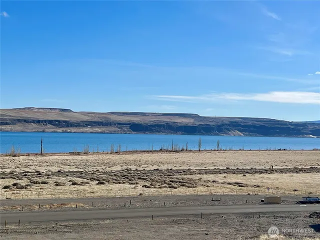 a view of a room with an empty space and wooden floor