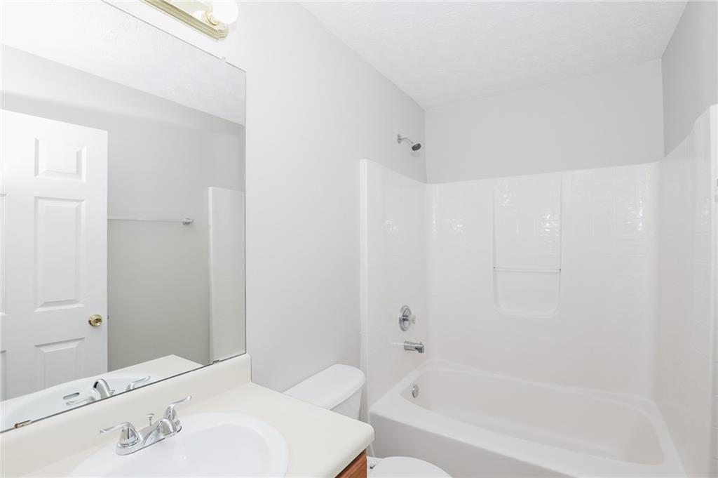 5896 Strathmoor Manor Circle Lithonia, GA 30058 - Photo 16 of 19 a bathroom with a bathtub and shower