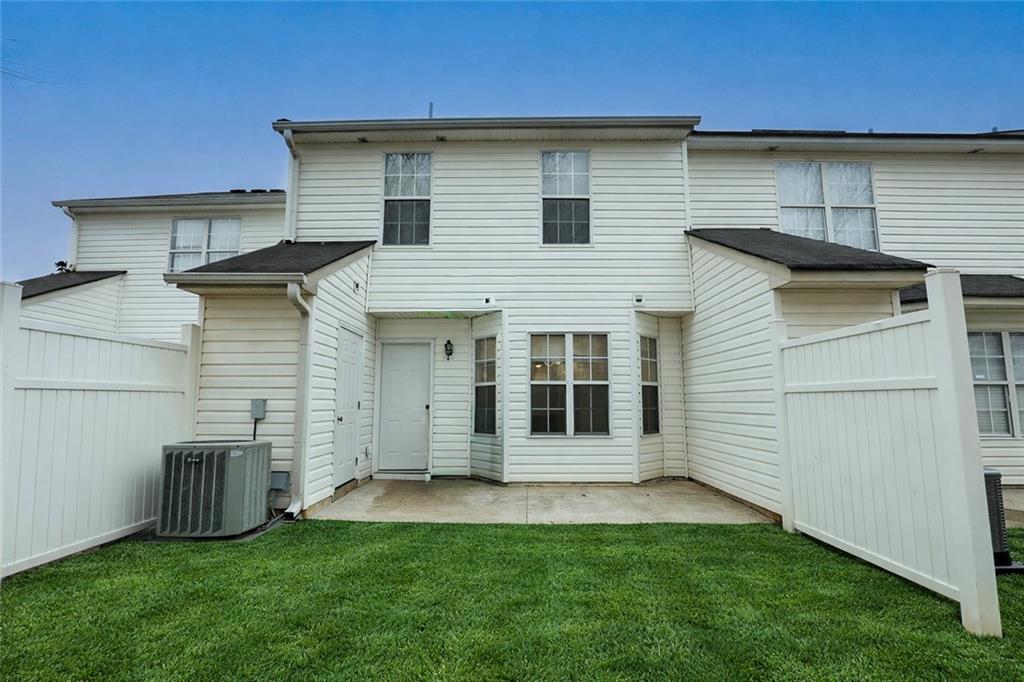 5896 Strathmoor Manor Circle Lithonia, GA 30058 - Photo 17 of 19 a view of a house with a backyard